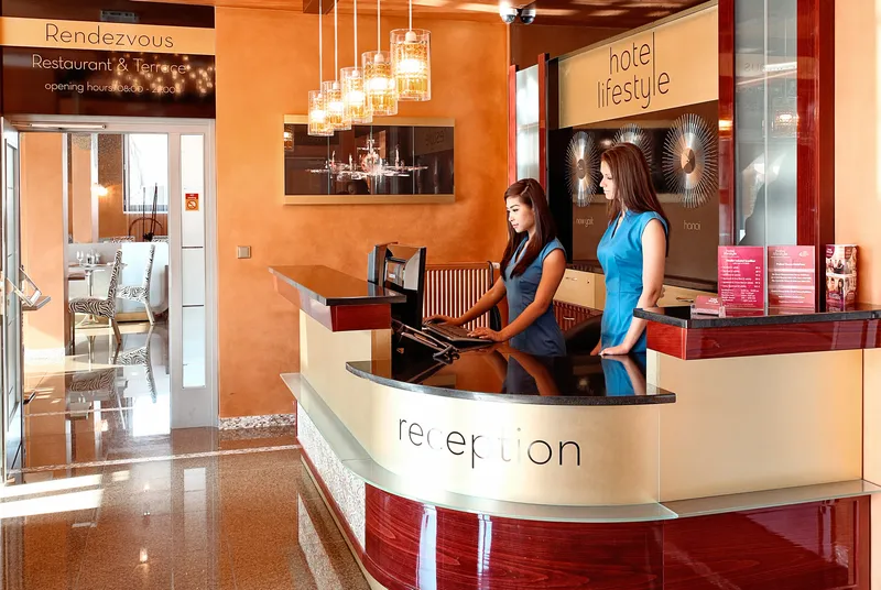 Reception desk at Lifestyle Hotel Prague with staff greeting guests